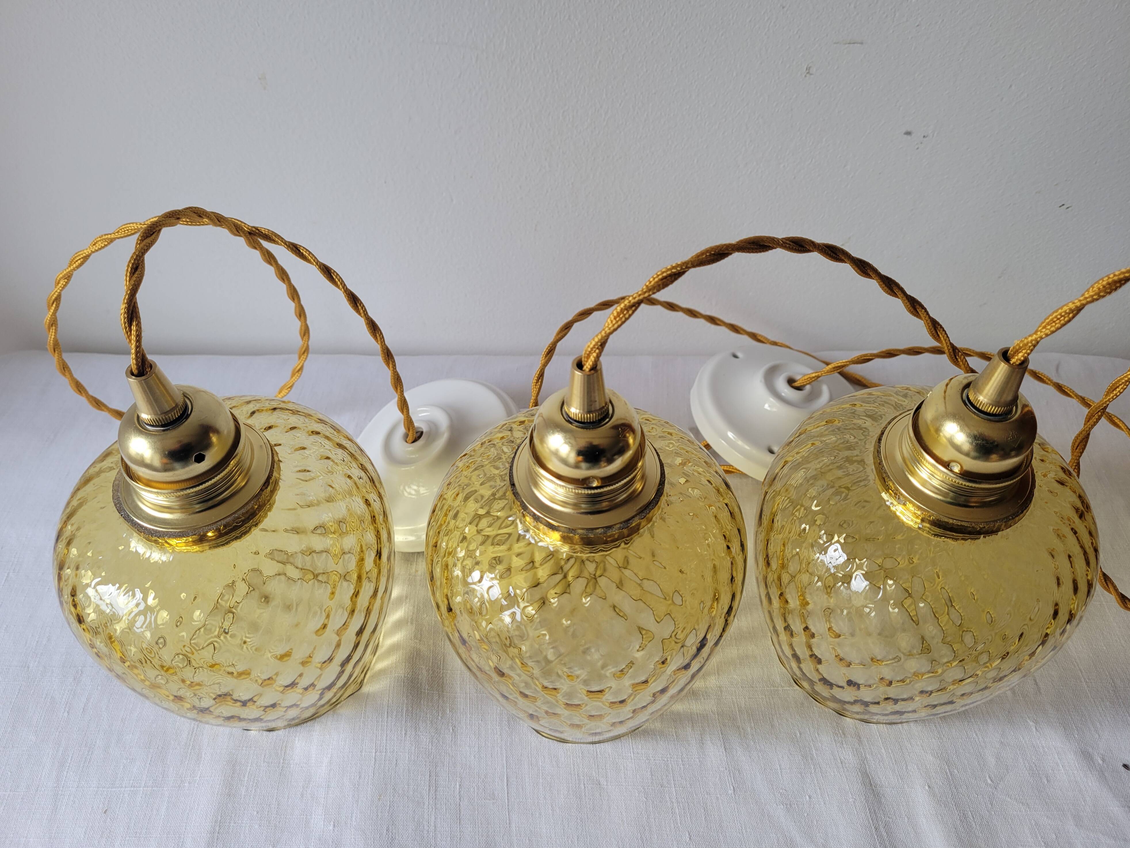 Trio of yellow glass pendant lights