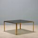 Vintage coffee table in brass and smoked glass, 1970s design.