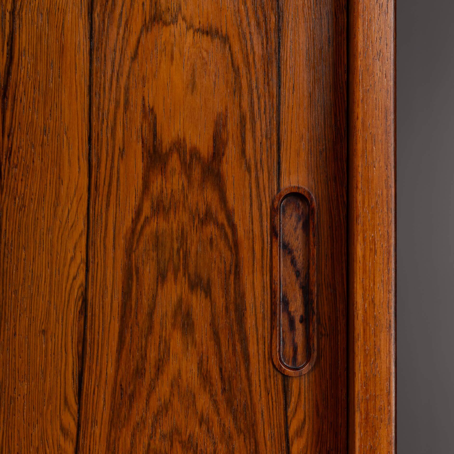 Rosewood library designed by Danish designers with doors by Hundevad & Co, 1960s.