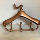 Wall mounted coat rack in the shape of a hanger