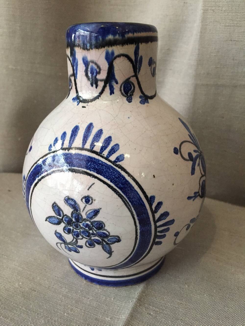 Small white decorative vase with blue floral decoration