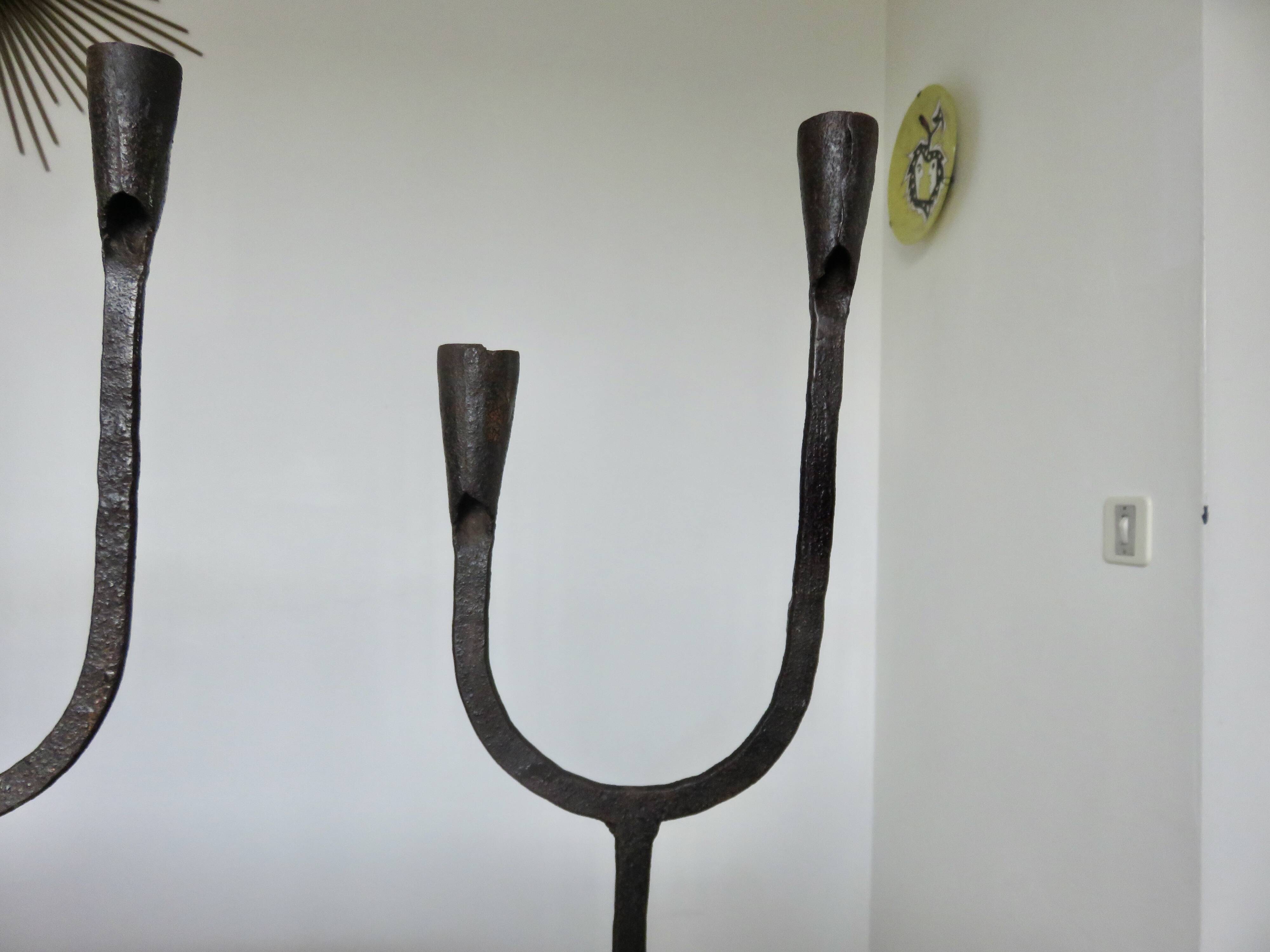 Pair of antique wrought iron candlesticks