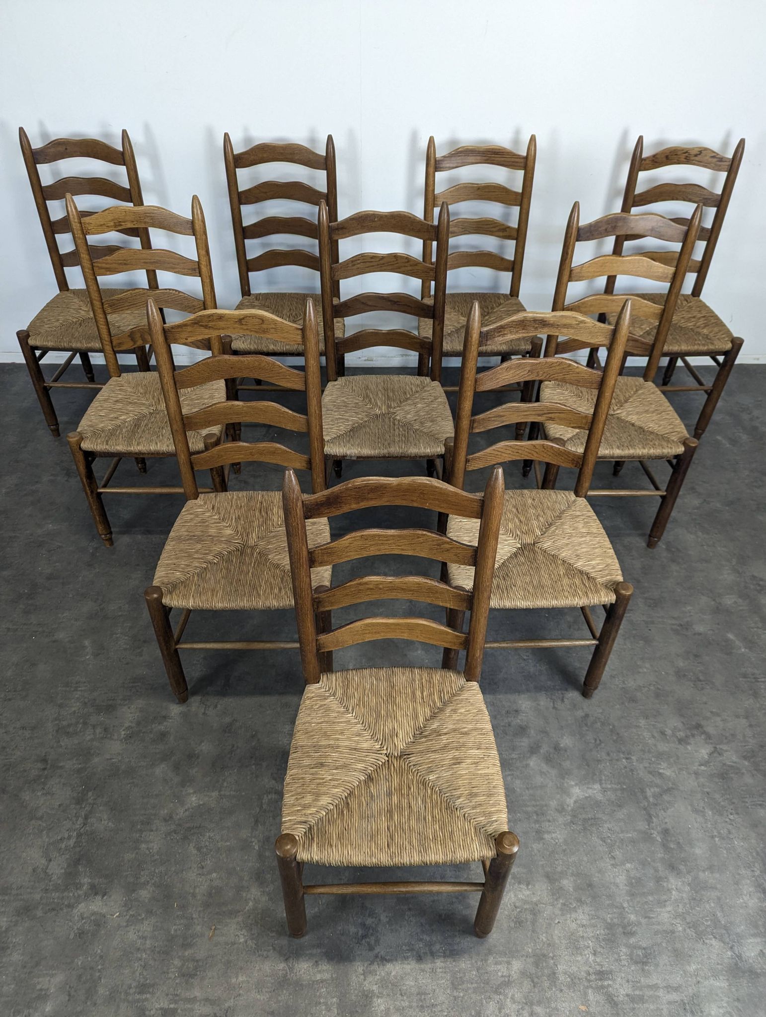 Series of 10 chairs in the style of Charlotte Perriand.
