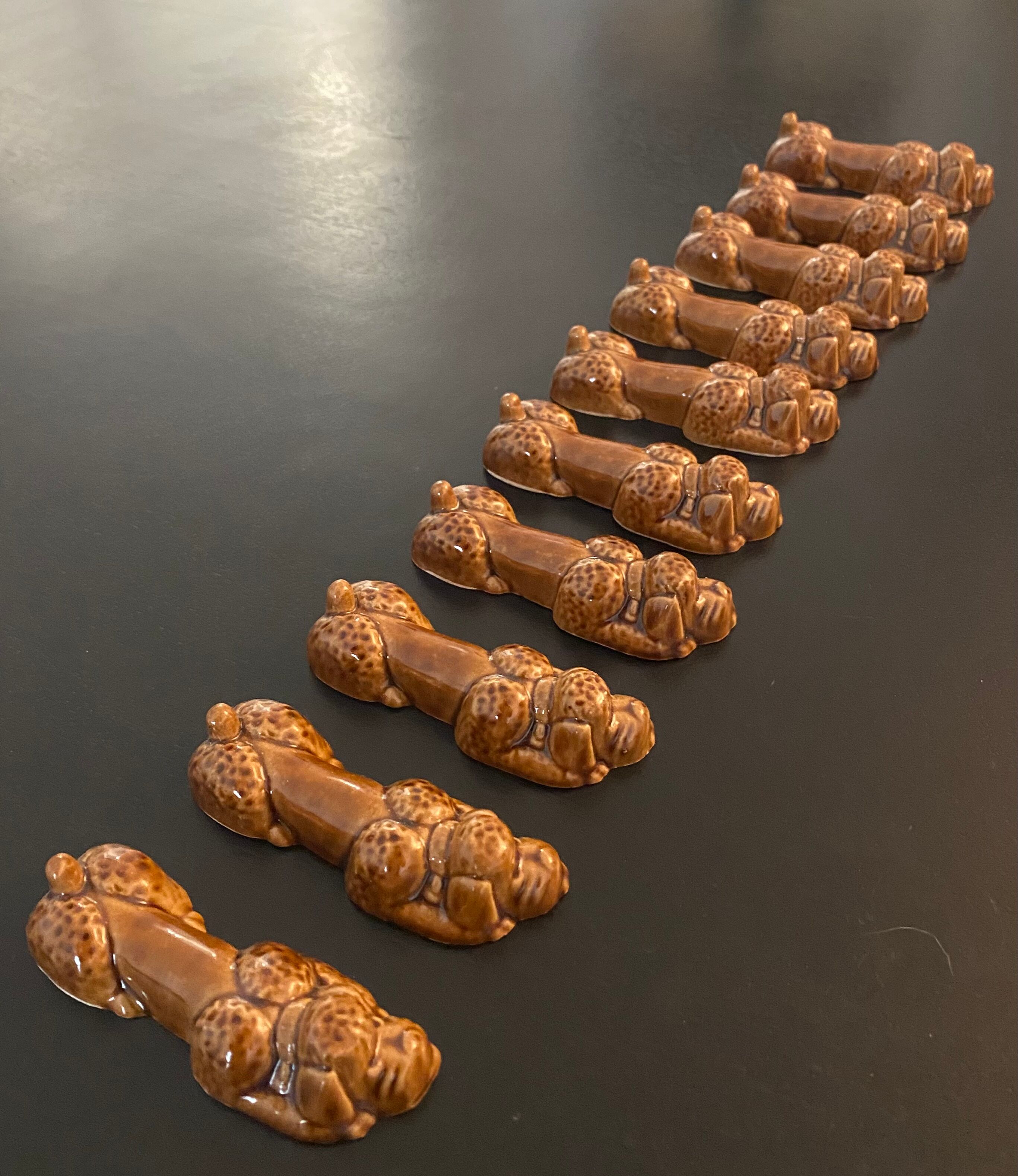 10 ceramic knife holders in the shape of a recumbent poodle
