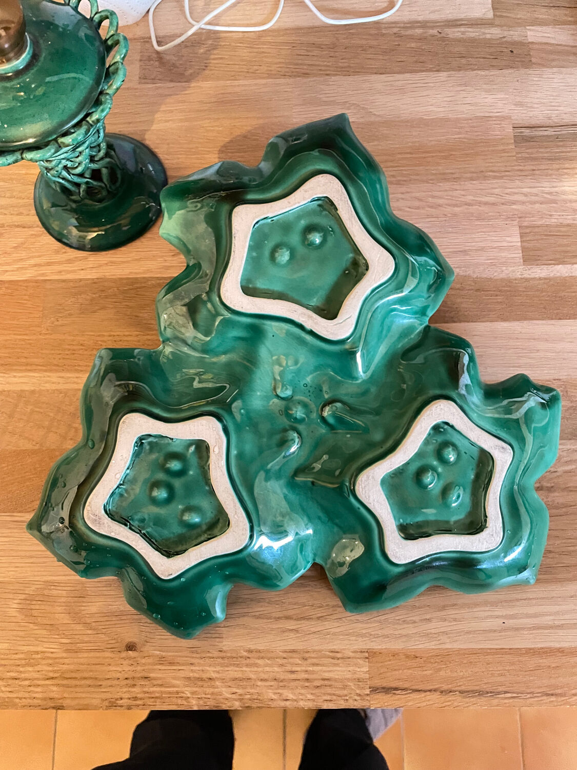 Old dish in green slip decor 3 vine leaves and an apple