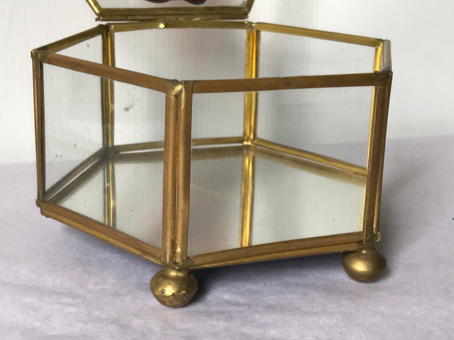 Glass box and hexagonal brass enamelled floral decoration
