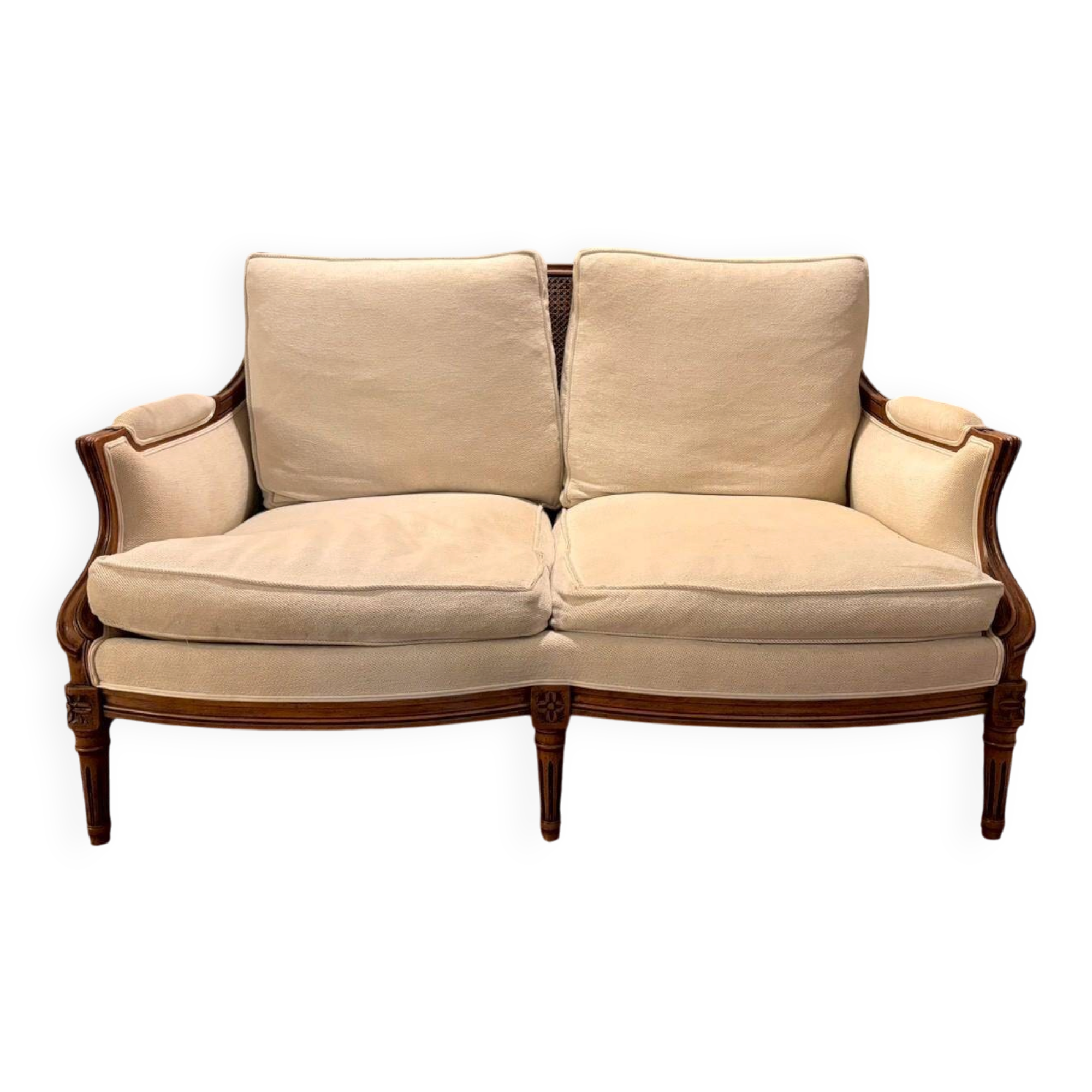 Two-seater canapé by Roche Bobois in Louis XVI style — carved wood, caned sides.