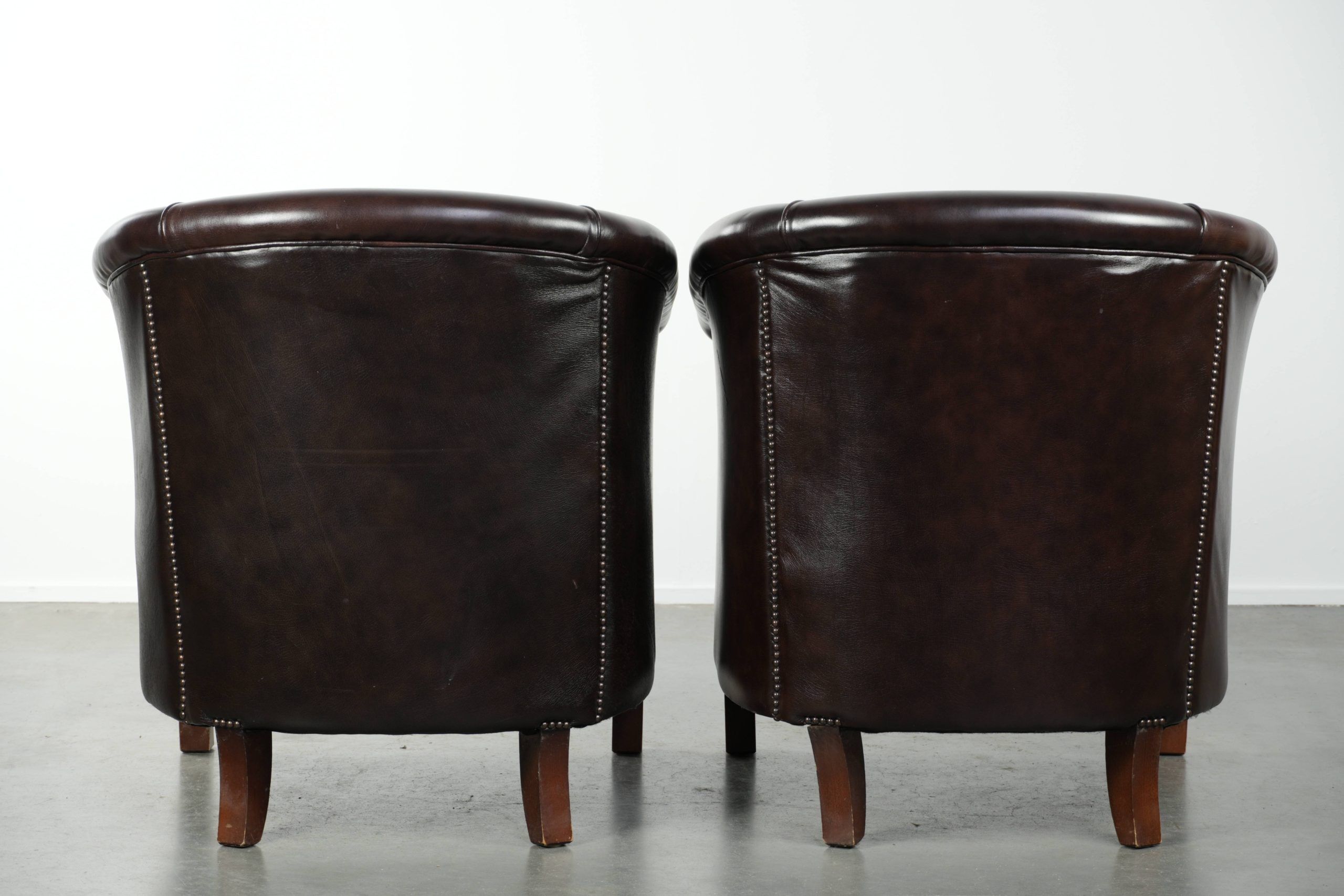 Set of two cowhide club armchairs in good condition with a English design