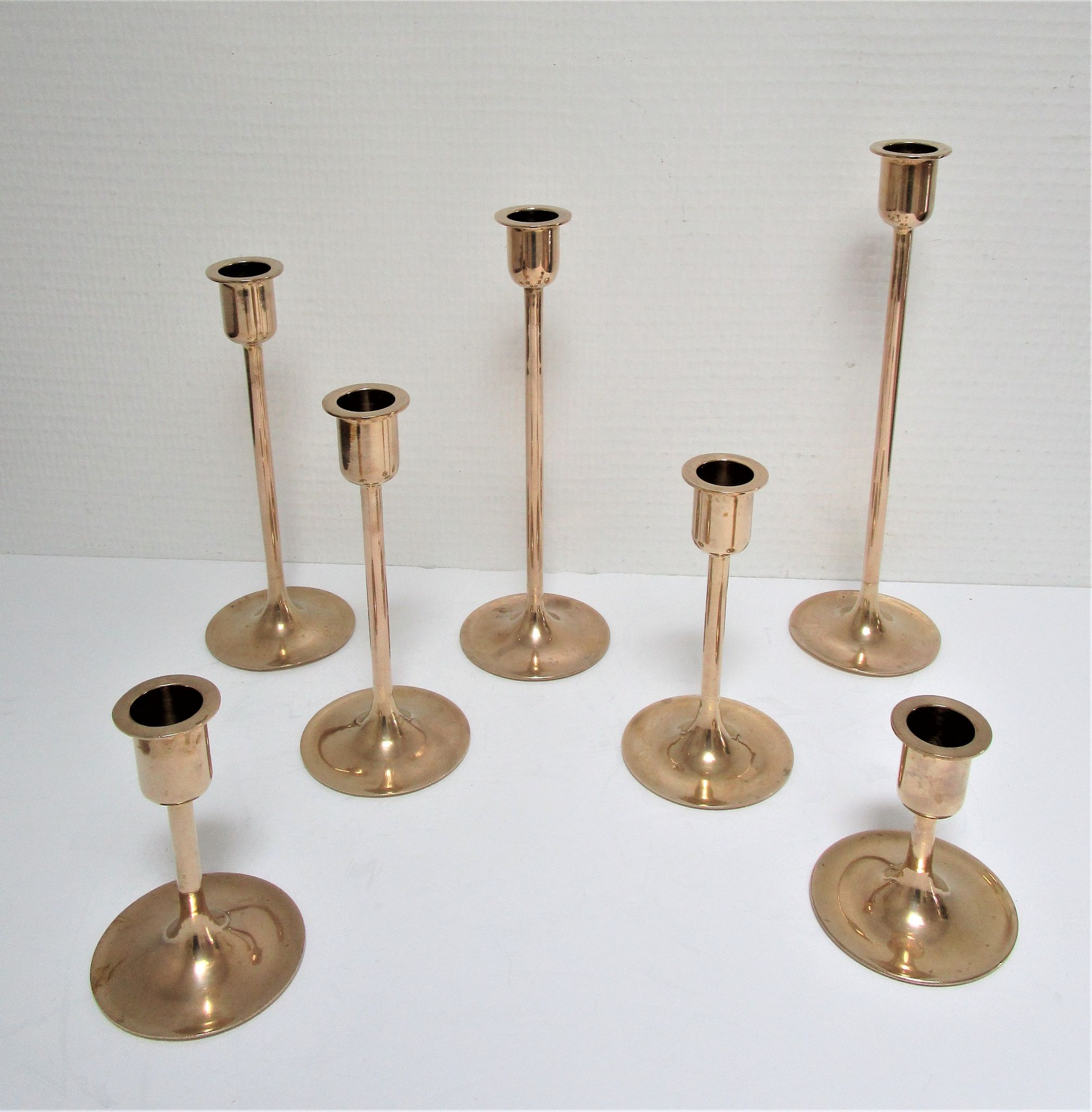 Series of seven candle holders solid brass