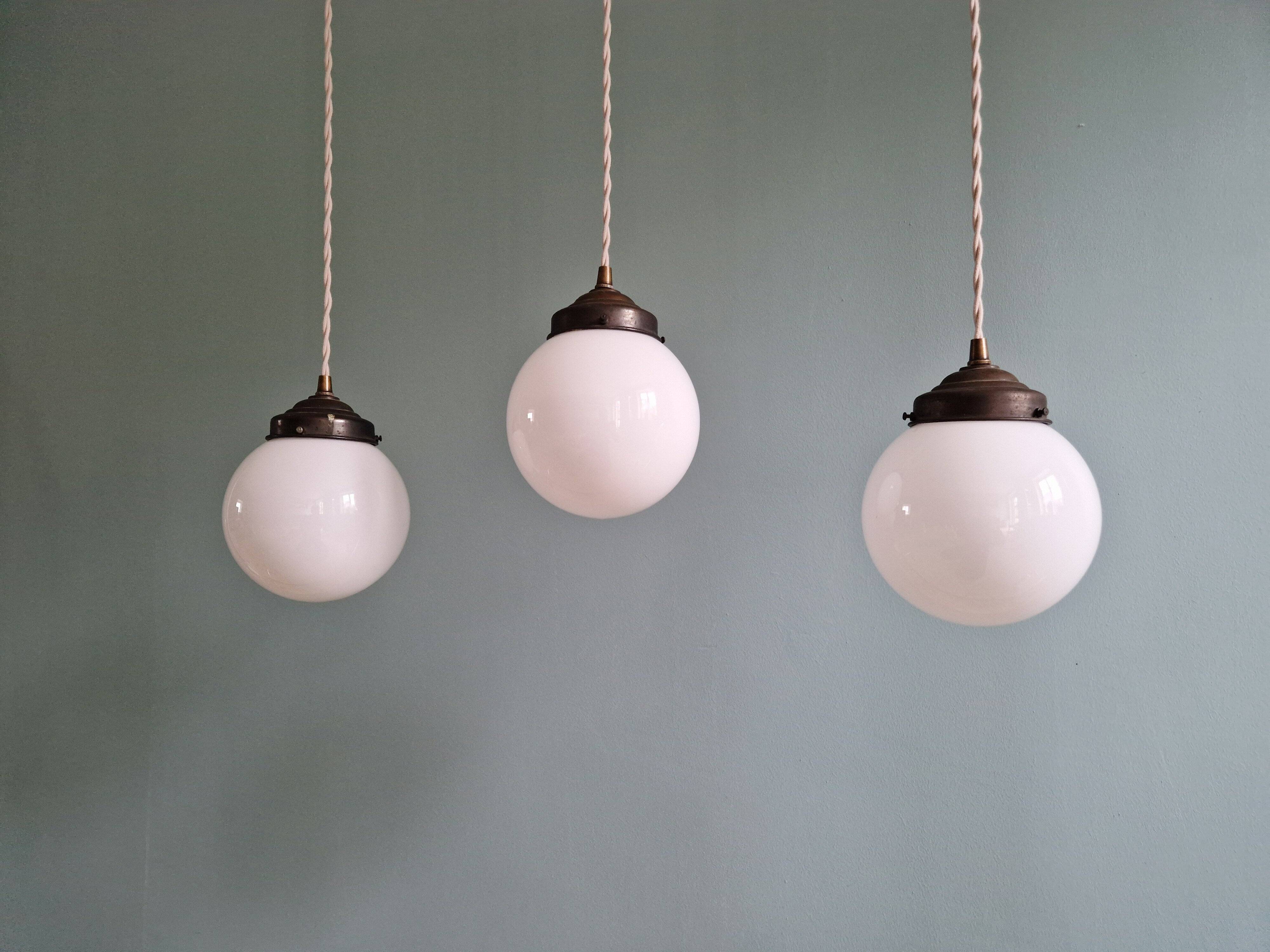Art Deco trio of suspensions in white opaline, 1930s