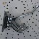 Wall-mounted coat rack in chromed metal with 4 adjustable hooks