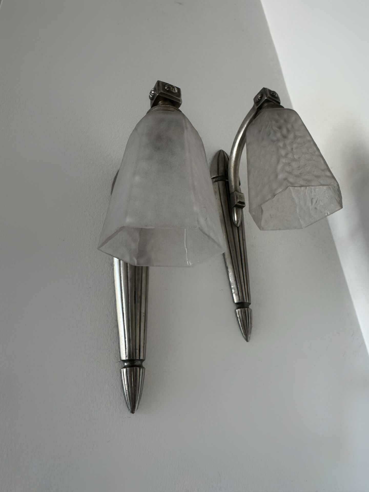 Silver Art Deco wall lights with frosted glass.