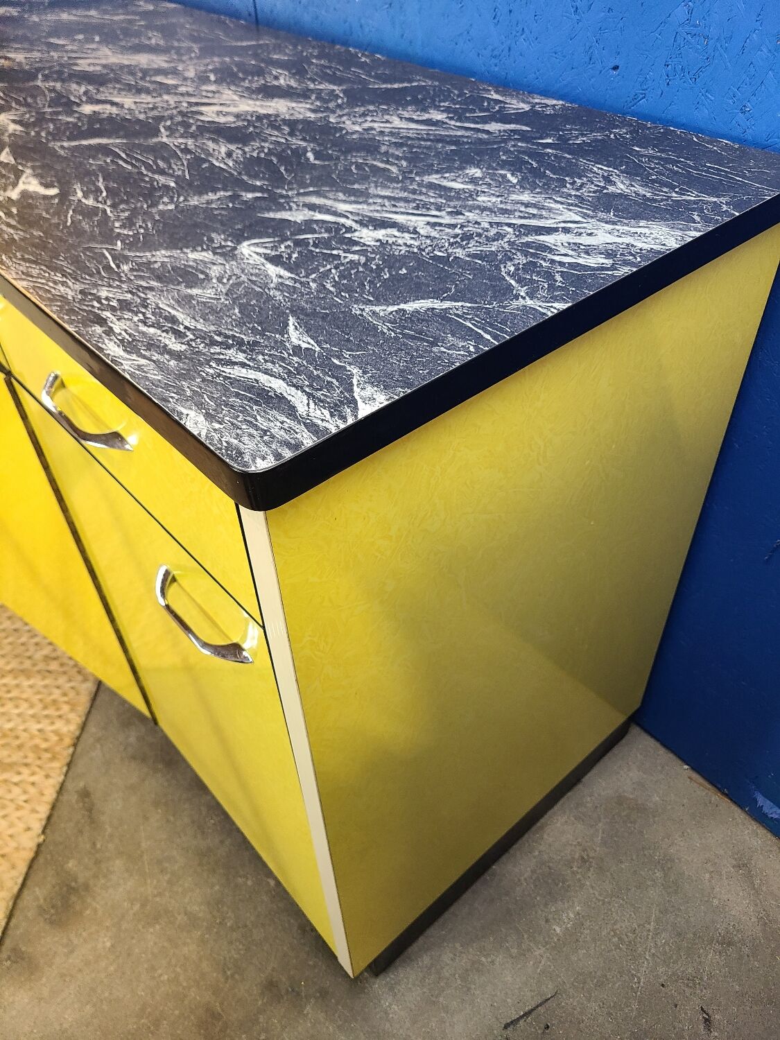 Vintage yellow sideboard, and black marble top.
