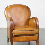 Unique, luxurious sheepskin armchair combined with wood and finished with decorative nails