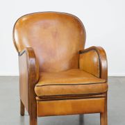 Unique, luxurious sheepskin armchair combined with wood and finished with decorative nails