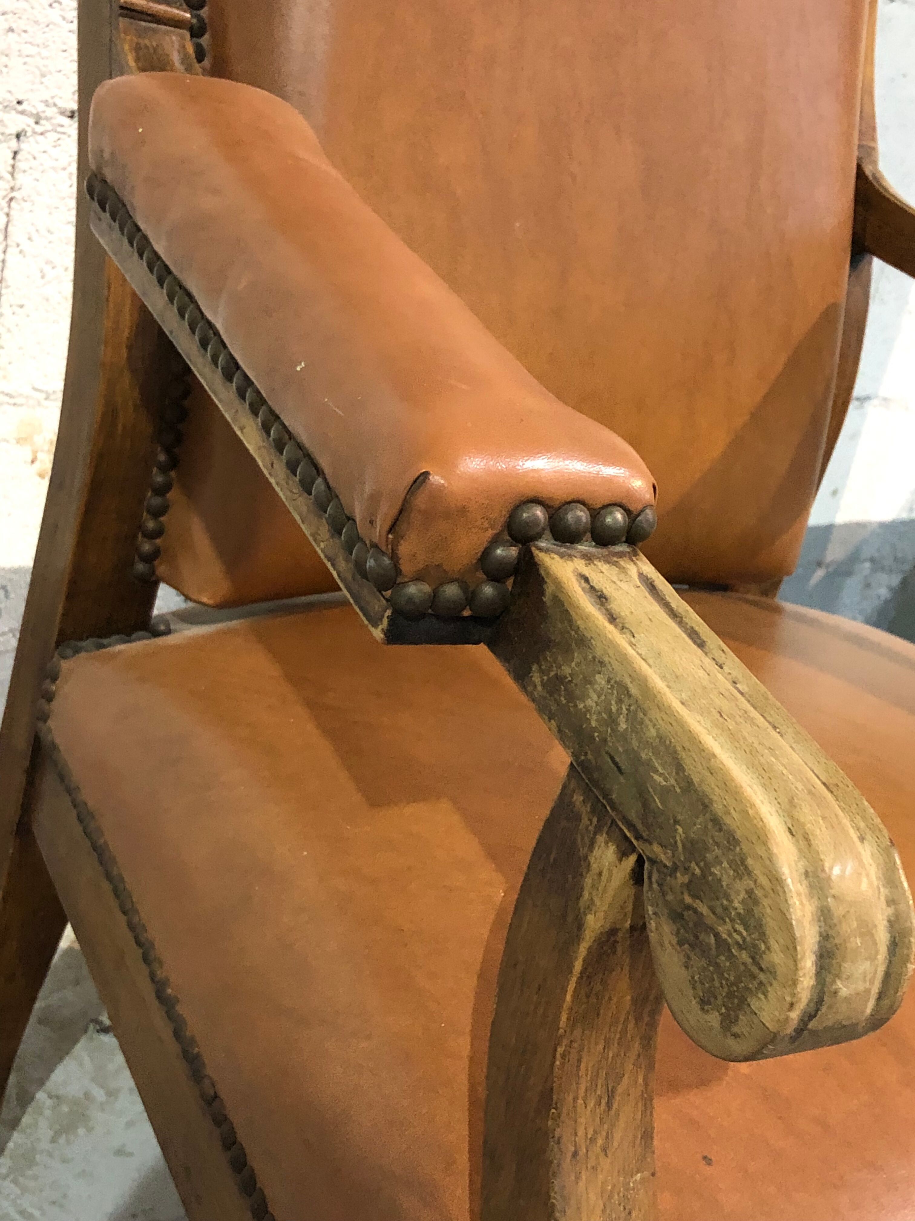 Old Voltaire armchair in light brown leather
