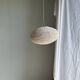 Average suspension in natural rattan and linen, Japanese-style, flattened oval in pink.