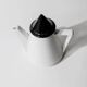 Vintage ceramic coffee pot or teapot from the 1980s, postmodern Memphis design, black and white triangles.
