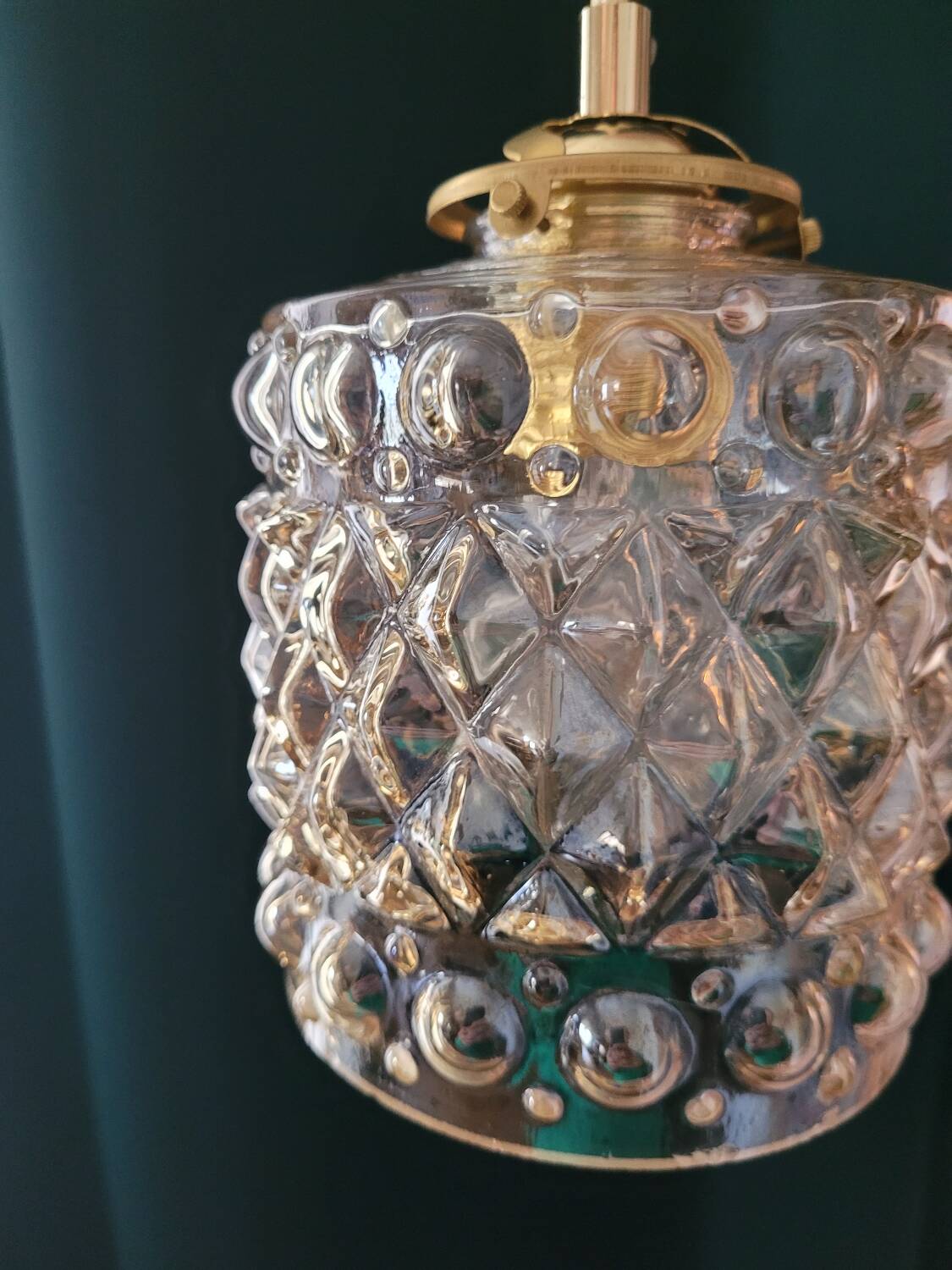 Moulded glass lamp with a cubic-spherical relief design.