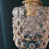 Moulded glass lamp with a cubic-spherical relief design.