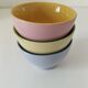 Set of three pastel two-tone mini bowls in glazed ceramic.