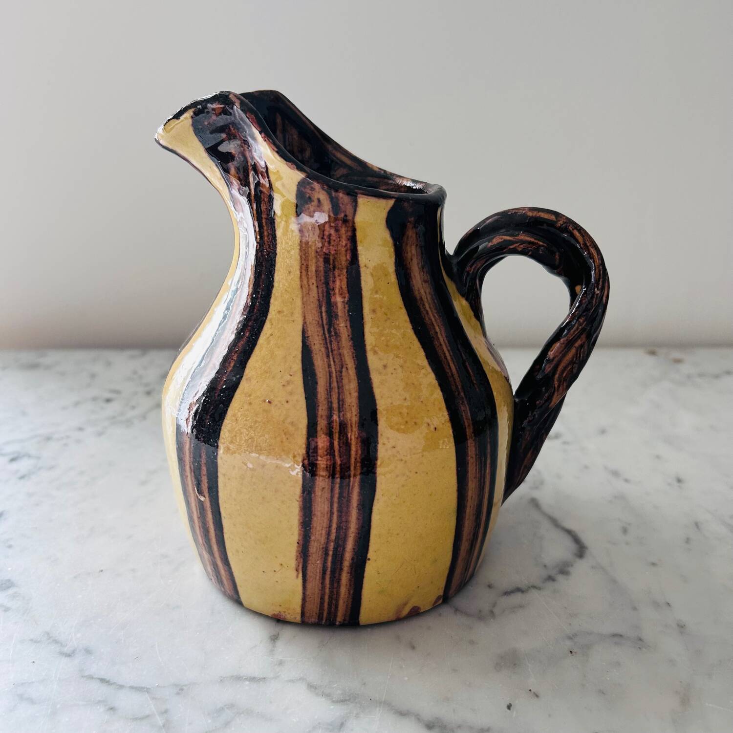 Striped decorative pitcher signed