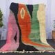 Large handmade Moroccan rug with colourful patterns.