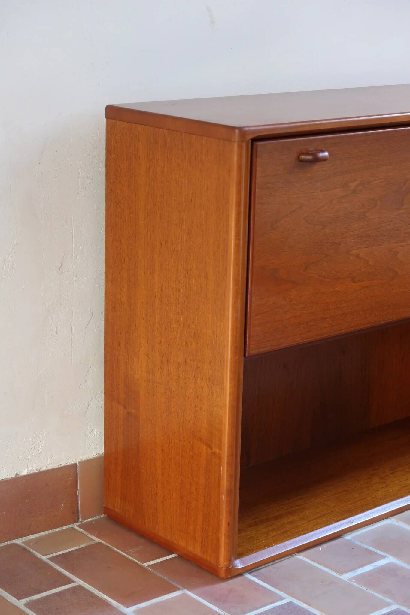 Vintage teak bar cabinet with black glass interior.