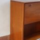 Vintage teak bar cabinet with black glass interior.