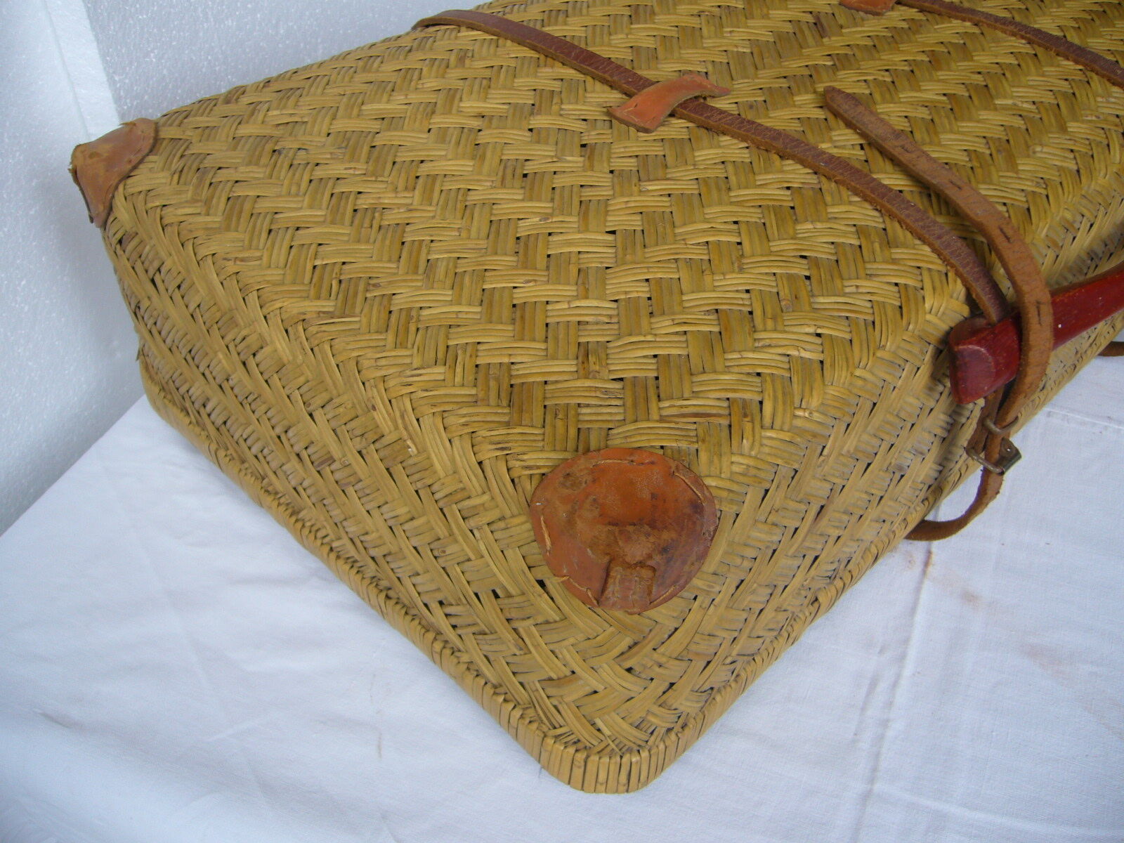 Old rattan case with leather straps and wooden handle