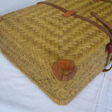Old rattan case with leather straps and wooden handle