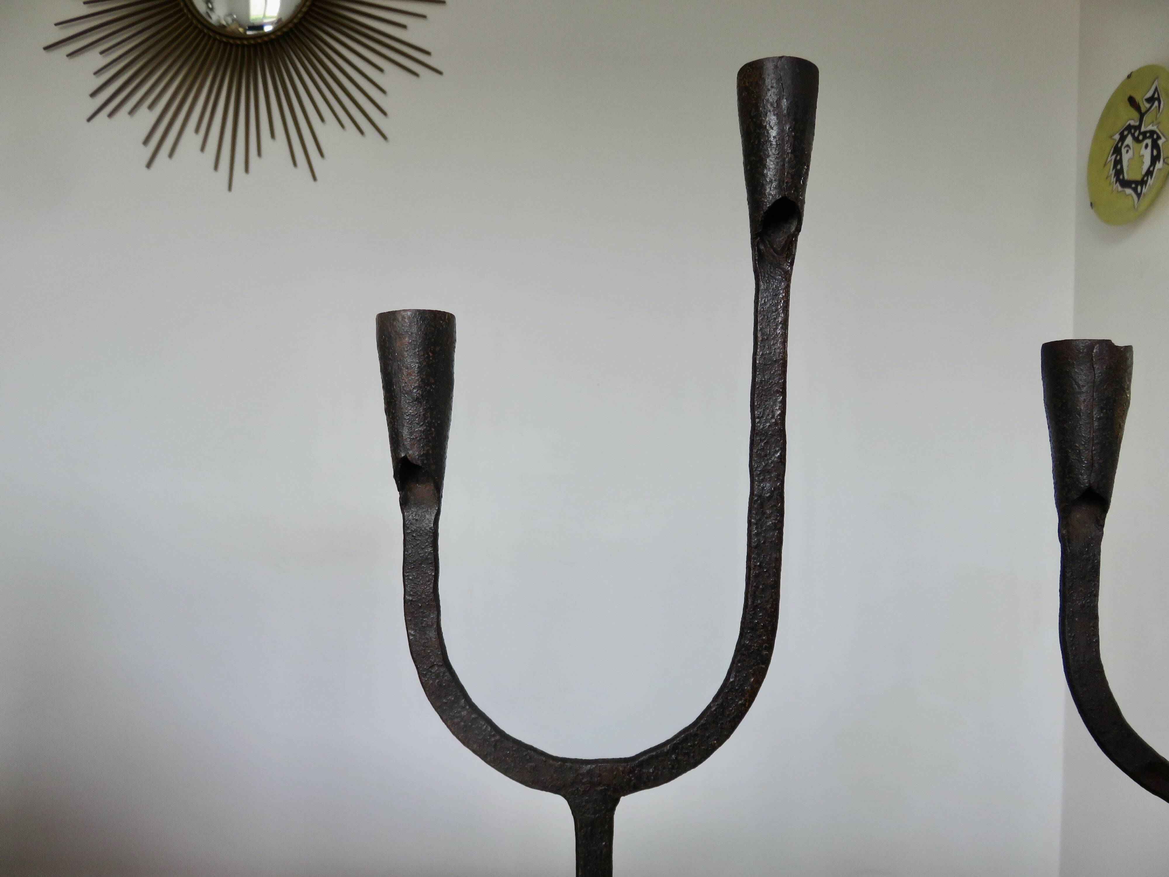 Pair of antique wrought iron candlesticks