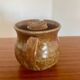 Large antique brown glazed stoneware jug with cork stopper.