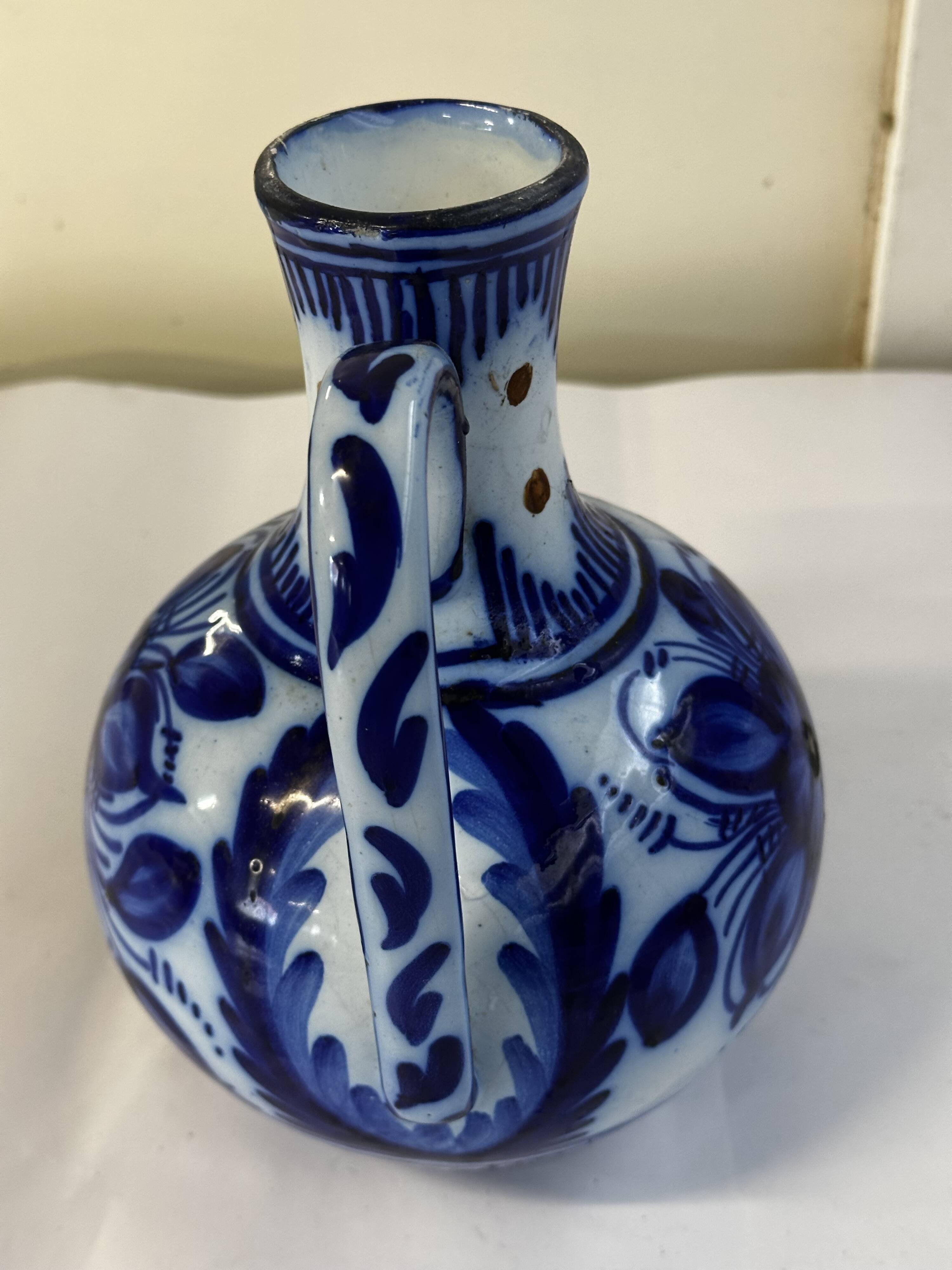 Glazed ceramic carafe with floral decoration