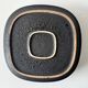 Large decorative ceramic catchall with red and black spiral pattern.
