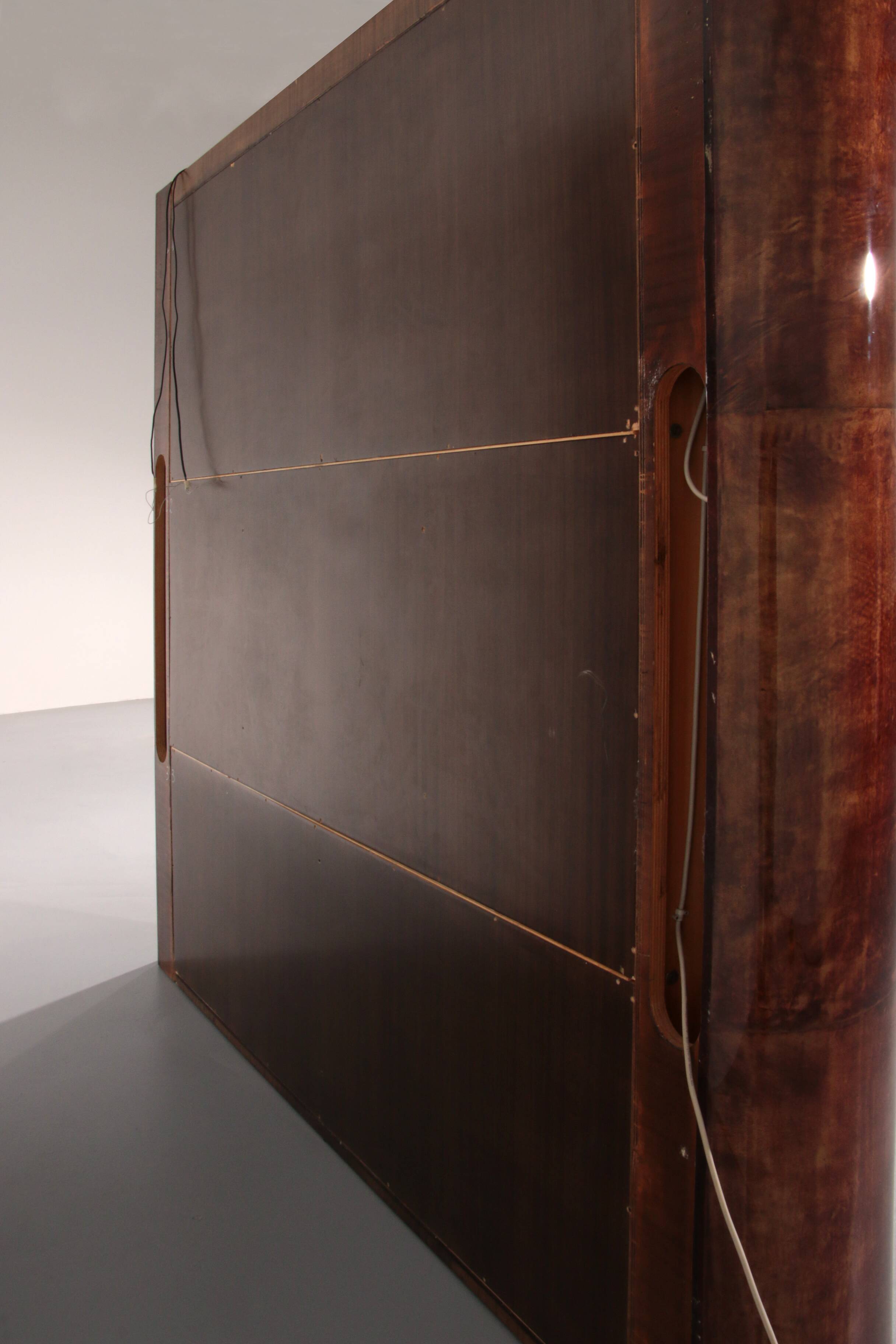Iconic Aldo Tura brown goatskin bar cabinet with electric lift & mirror interior.