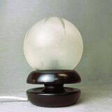 Small black wooden table lamp with frosted glass globe