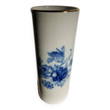 White porcelain vase from Limoges with blue decoration and gold rim.