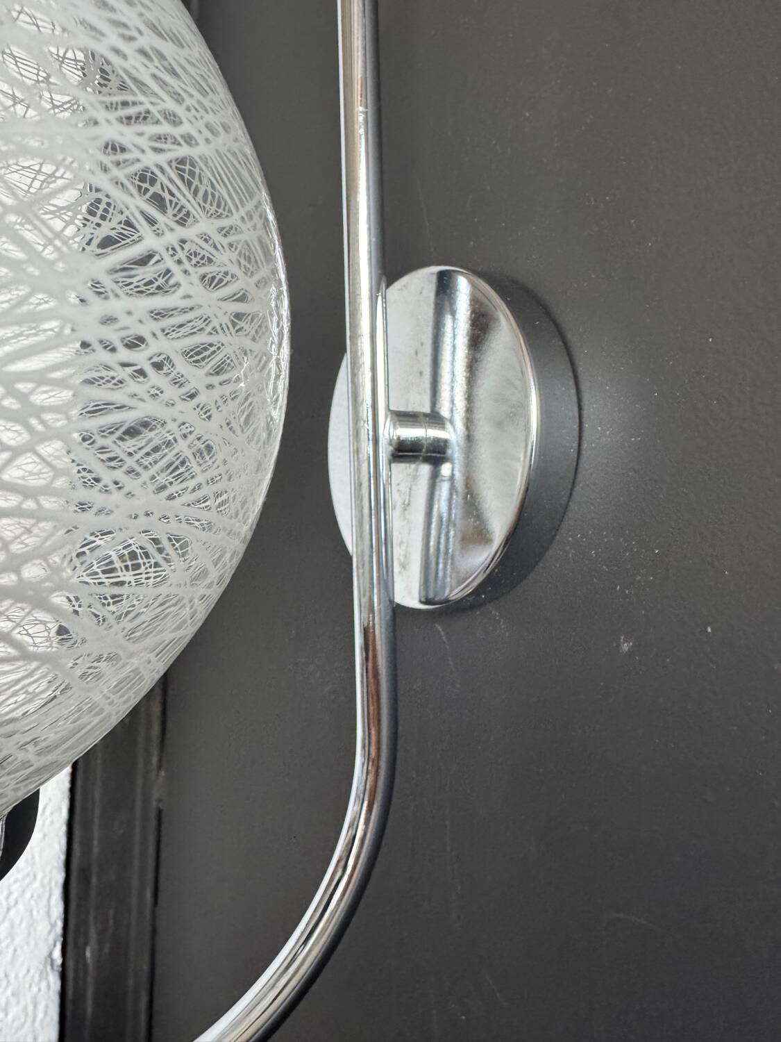 Chrome wall light with blown glass from the 1970s.