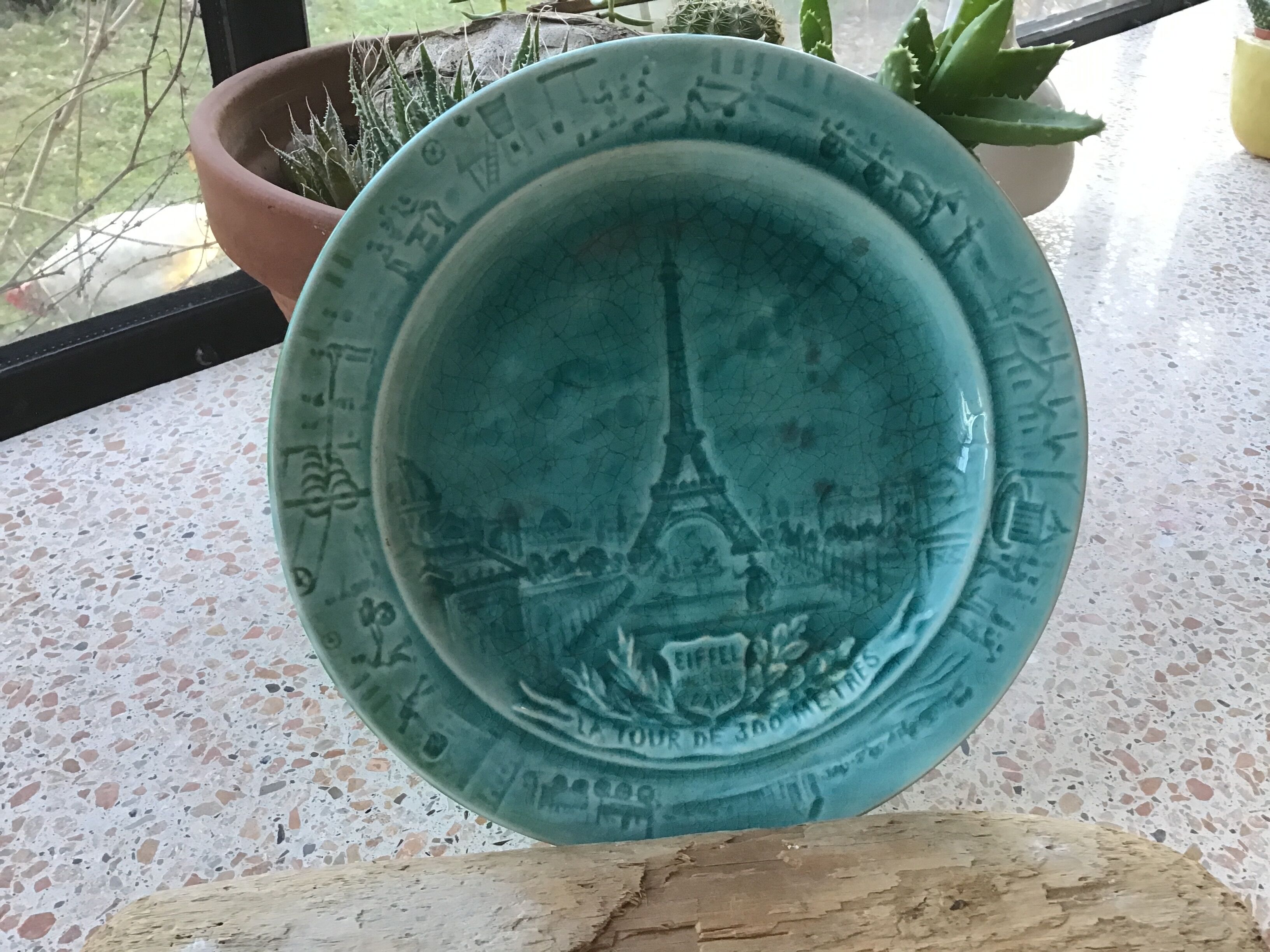 Cracked earthenware plate the Eiffel Tower