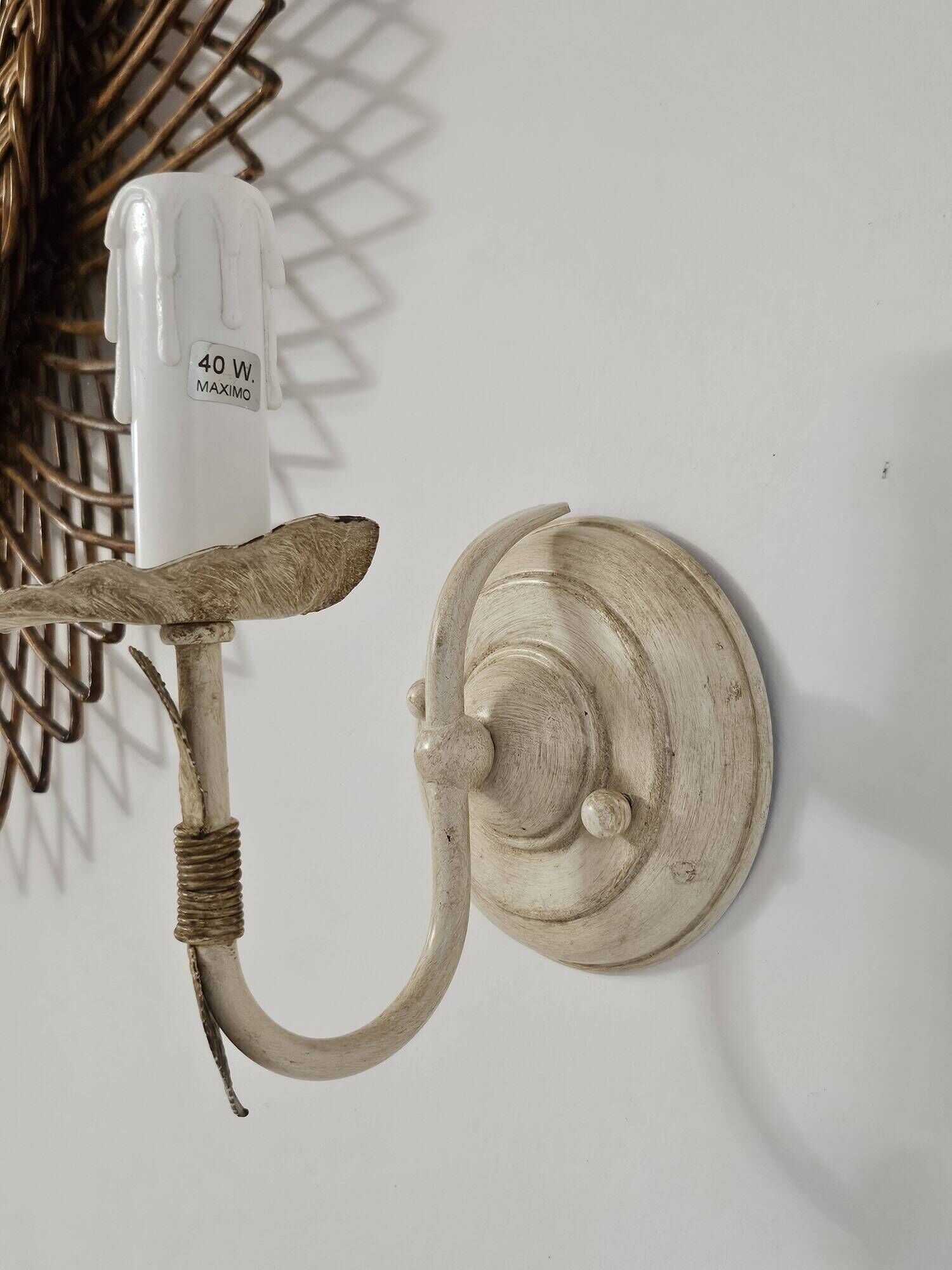 Pair of cream patinated metal wall sconces with floral decoration.