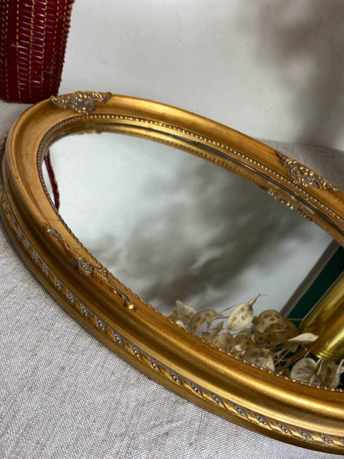 Oval-shaped gilded wooden mirror