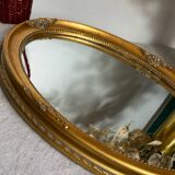 Oval-shaped gilded wooden mirror