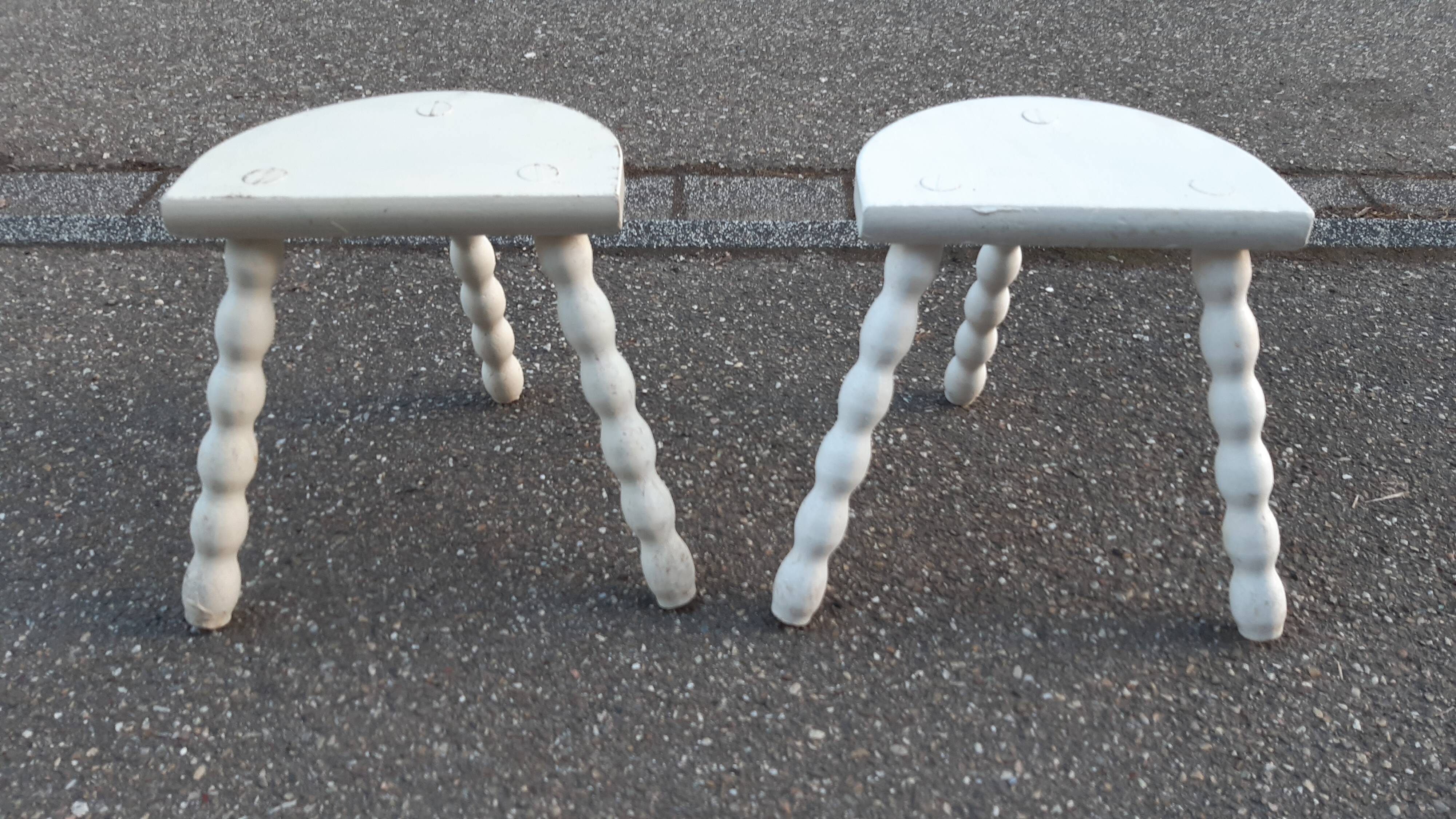 Duo of milking stools with turned legs.
