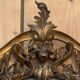 Large gilded wooden mirror, richly carved with winged dragons, 19th century