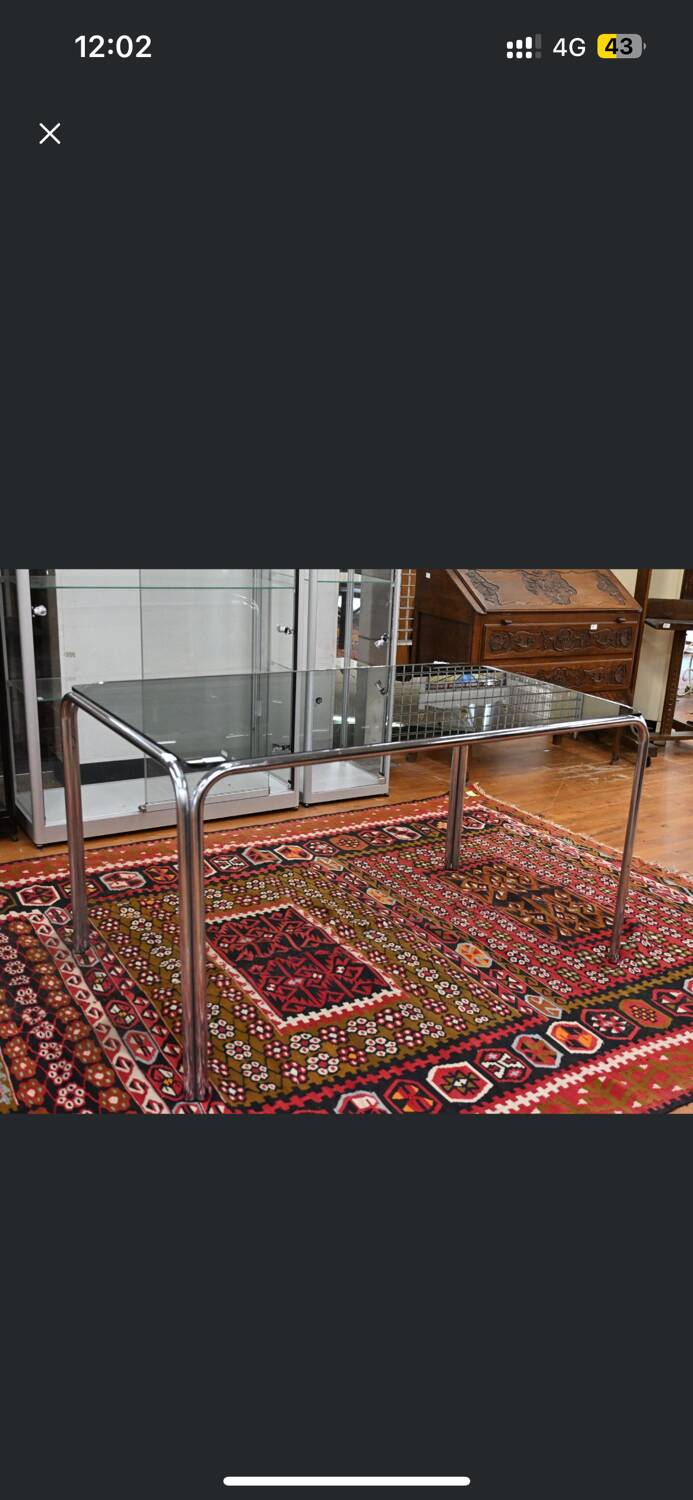 Vintage glass dining table with chrome legs.