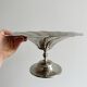 large dish on a shiny metal stand