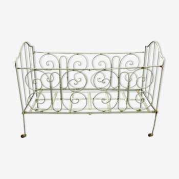 Cot in iron scrollwork decoration