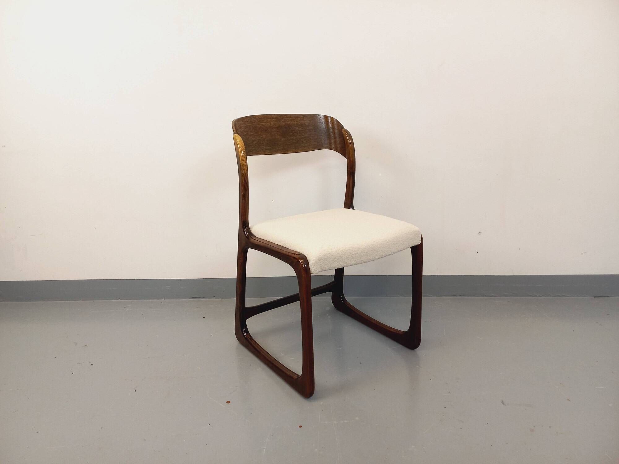 Vintage sled chair by Baumann in wood and boucle fabric.