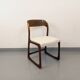 Vintage sled chair by Baumann in wood and boucle fabric.